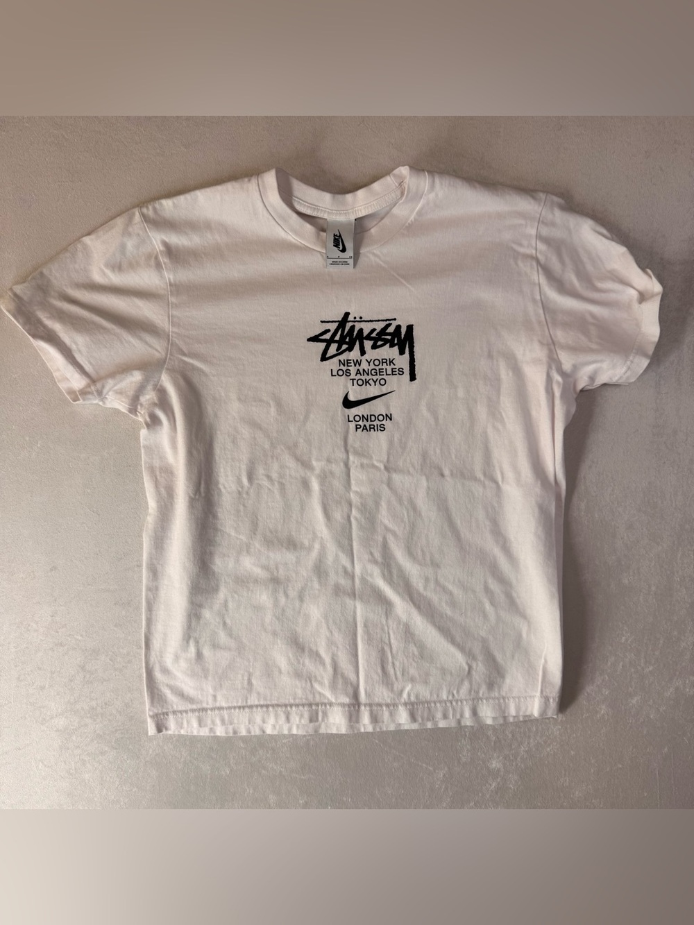White Nike X Stussy International Tee Features A Graphic Listing Global Cities